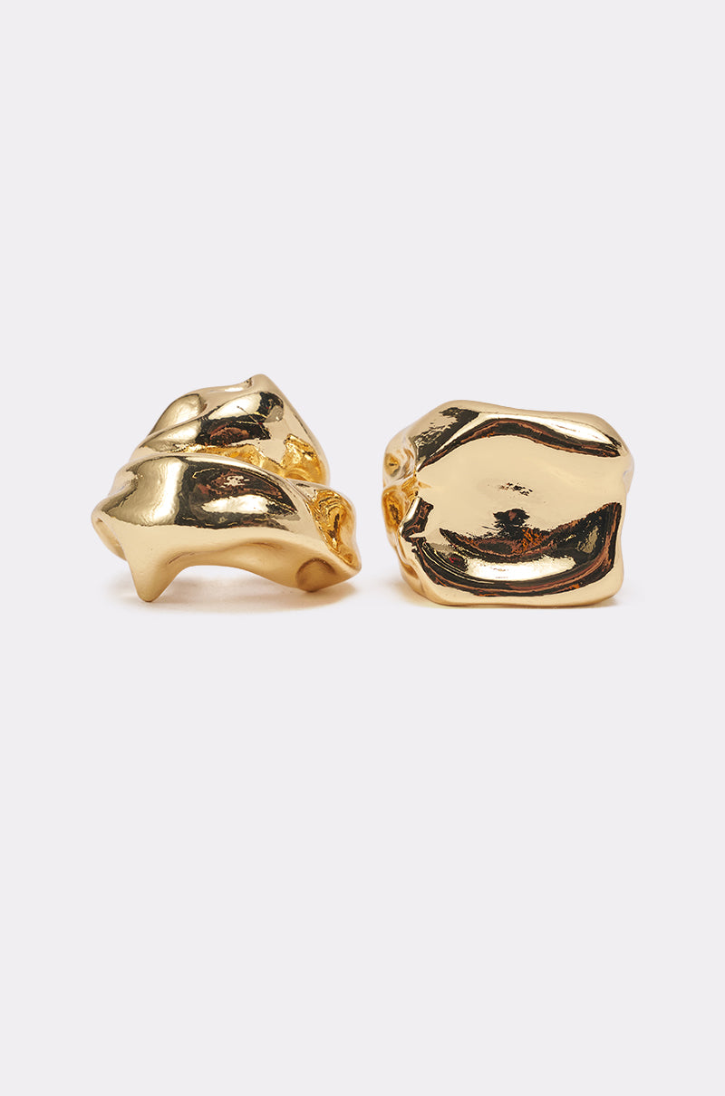Two gold, chunky, abstract-shaped rings from the MOLTEN DREAMS RING SET are displayed side by side on a plain white background. Their shiny, uneven surfaces give each ring an organic, sculptural and modern jewelry look. 0