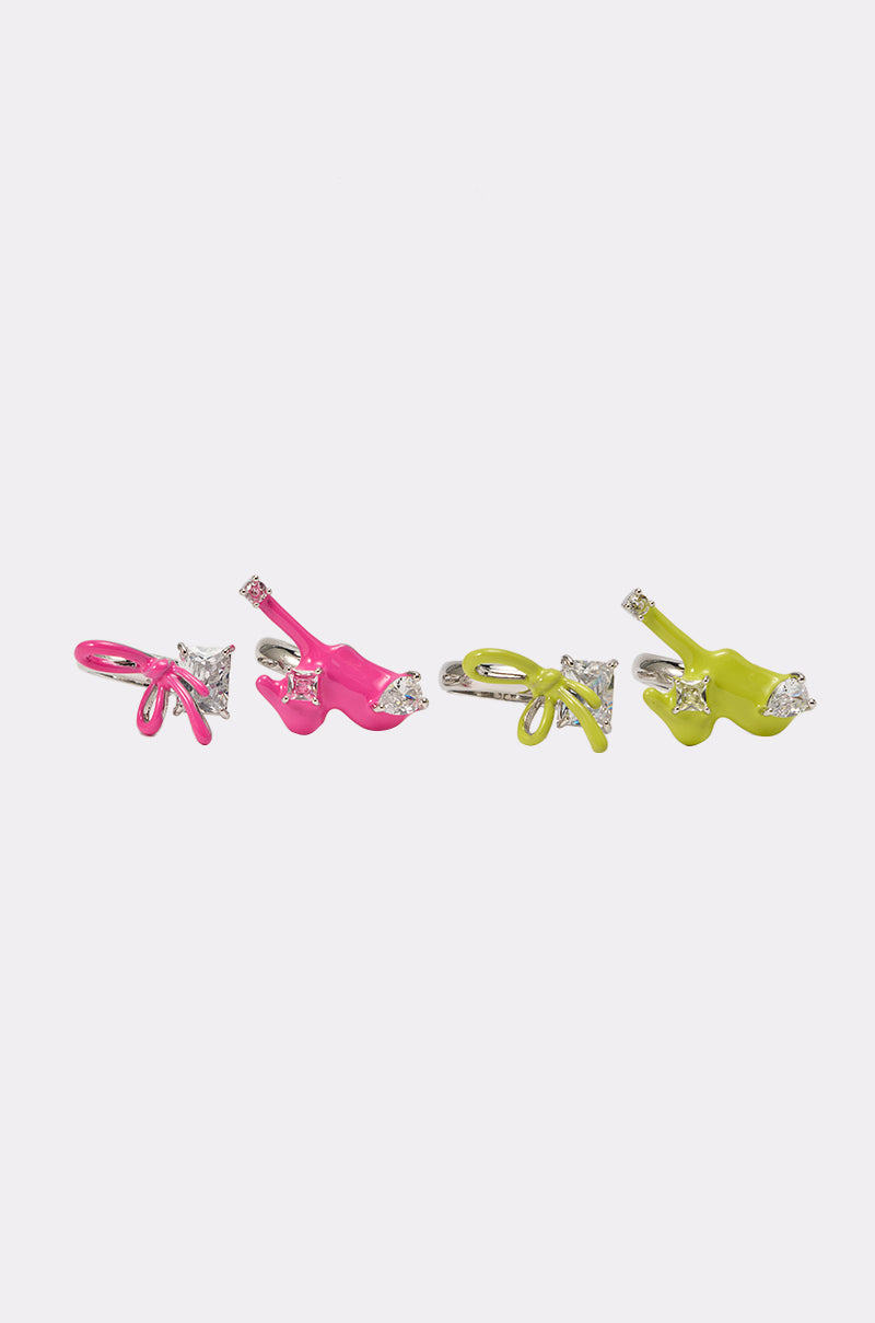 Two pairs of stud earrings shaped like bows—one bright pink, one lime green—with silver accents and a clear square gem. Perfect to pair with the TOO TRENDY RING SET or your favorite statement jewelry. 0