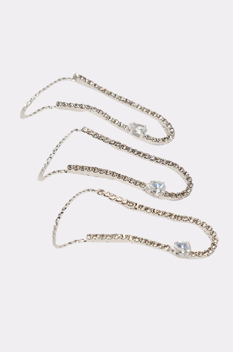 The WAVEY RING SET consists of three silver rings, each adorned with rhinestone detailing and featuring a larger, round-cut clear gem accent, displayed on a white background. 2