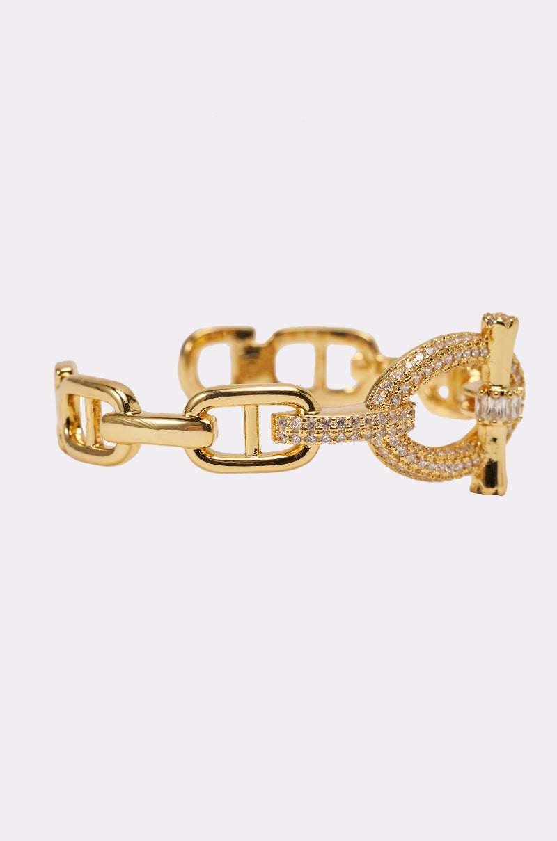 The IN THE LINK BRACELET is a chunky chain-link piece with a toggle clasp accented by sparkling crystals, shown on a plain white background. 2