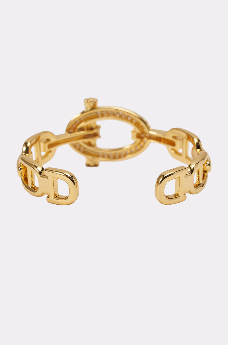 The IN THE LINK BRACELET is a gold chain-link bracelet with interlocking oval and "D" shaped links, shown against a plain white background. 3