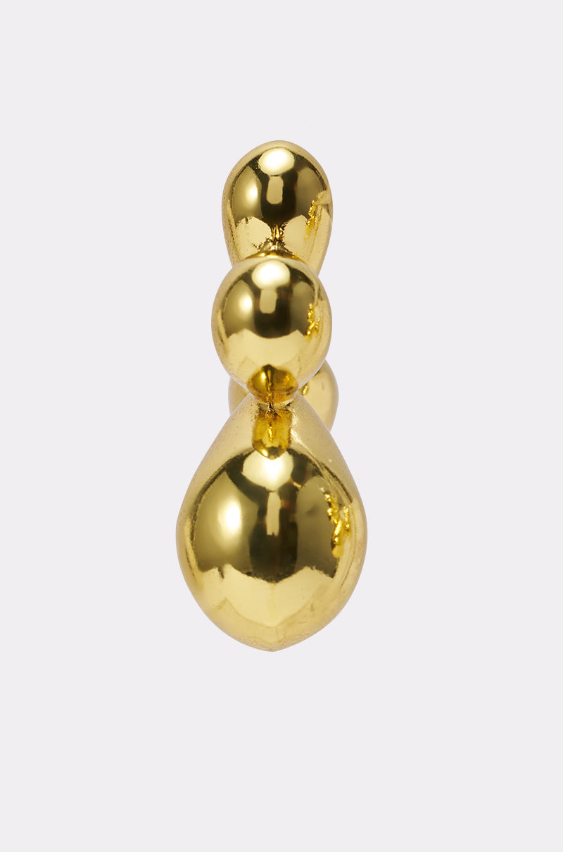 The FLOWER POWER EARRING features three polished spheres of increasing size, creating a sculptural, bubble-like design that adds a subtle yet striking statement against a plain, light background. 3