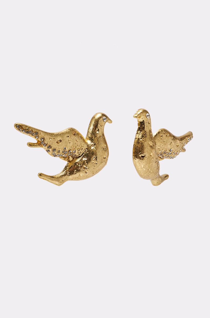 The SPREAD YOUR WINGS EARRING is a vintage-inspired, gold-tone pair shaped like doves in flight, with textured details and small stones on the wings, shown against a plain white background. 2