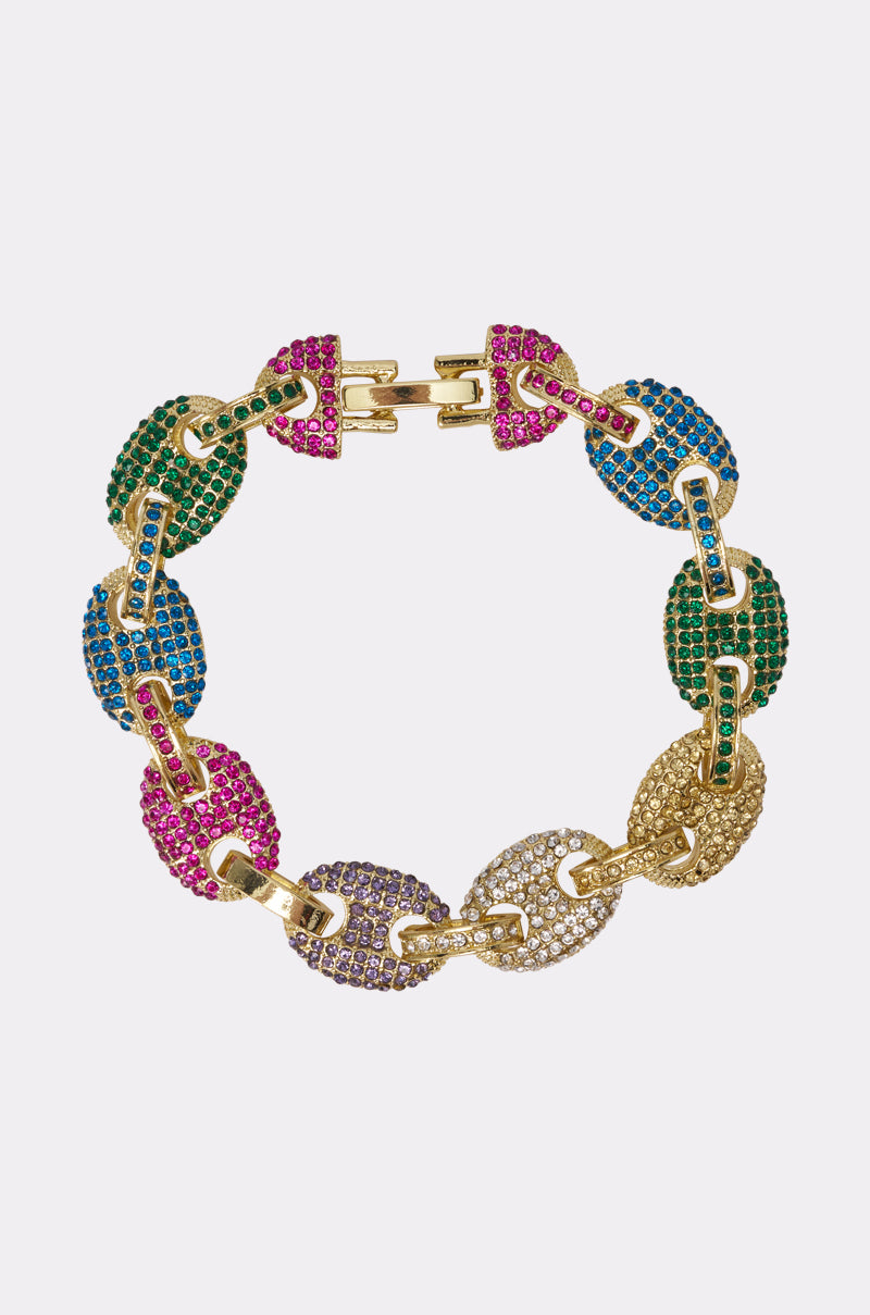 The SOOOOOO GOOD LUXE BRACELET is a multicolor chain featuring large oval links with green, blue, pink, purple, and clear rhinestones set in gold-tone hardware, displayed on a light background. 0