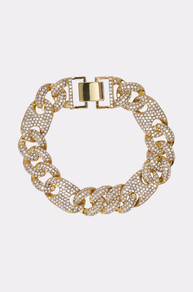 Add the TRAD CUBAN LUXE BRACELET to your stack—a gold bracelet with large, textured curb links encrusted with sparkling rhinestones and finished with a rectangular clasp for standout shine. 0