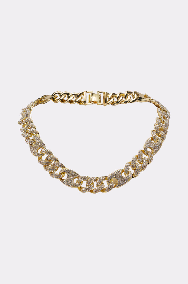 The BRUTUS LUXE NECKLACE, featuring large interlocking curb chain links with some adorned in sparkling clear stones, is displayed on a plain white background. 0