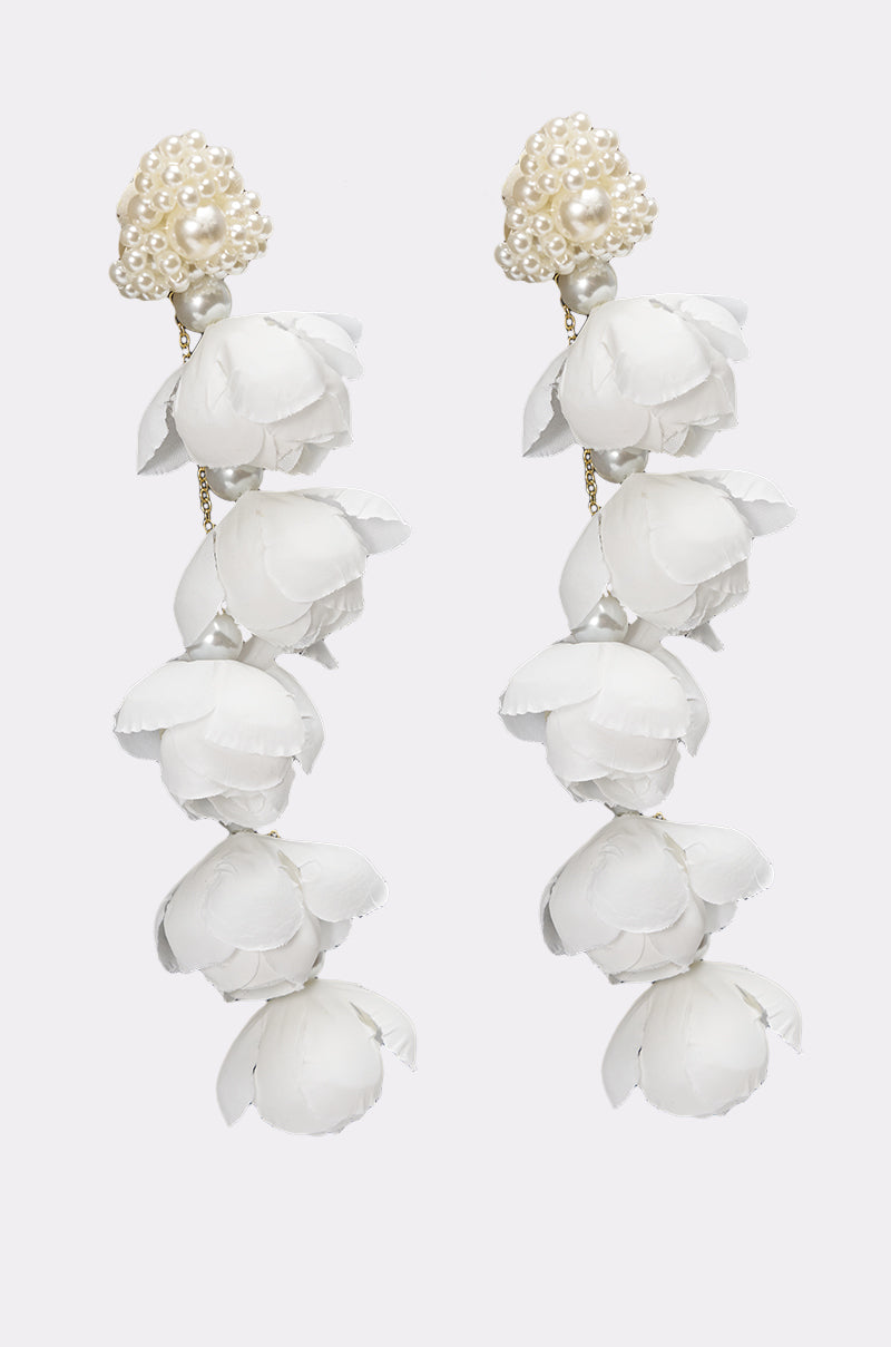 The LETS BLOOM DANGLE EARRING IN WHITE showcases clusters of white flower petals cascading elegantly, making these floral earrings a perfect choice for a bridal look. 2