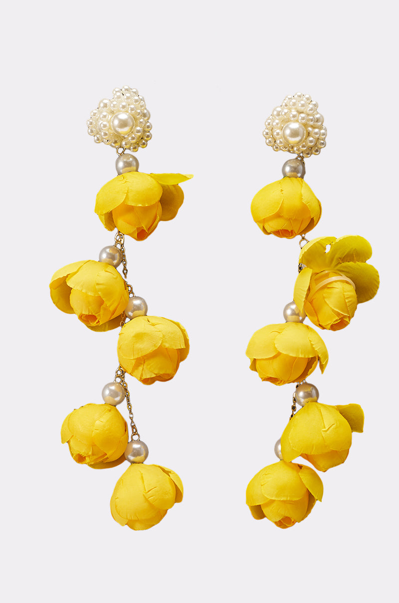 The LETS BLOOM DANGLE EARRING features clusters of bright yellow flower buds and small white pearl beads, attached to a larger pearl-embellished top, creating cheerful and decorative statement earrings. 1