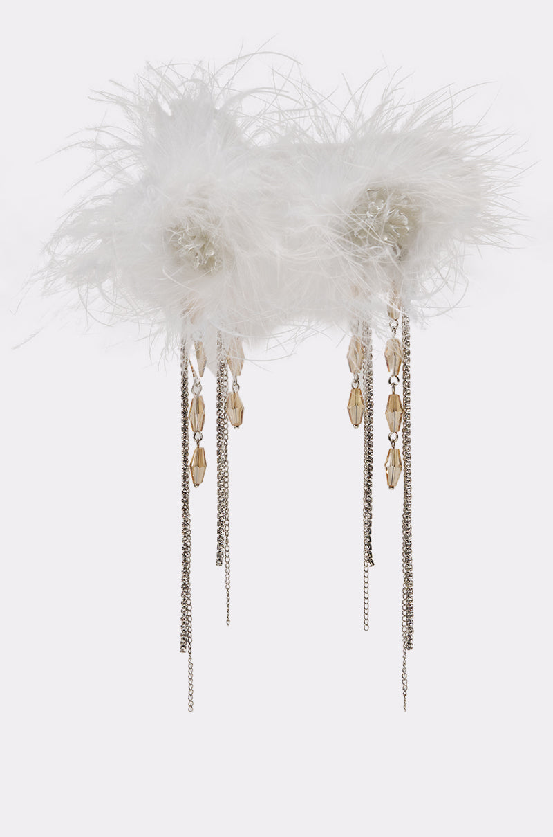 The LUXE LIVING FEATHER EARRING features white feathers, sparkling beads, crystal chain accents, and dangling silver chains with gold charms, displayed on a plain white background. 0