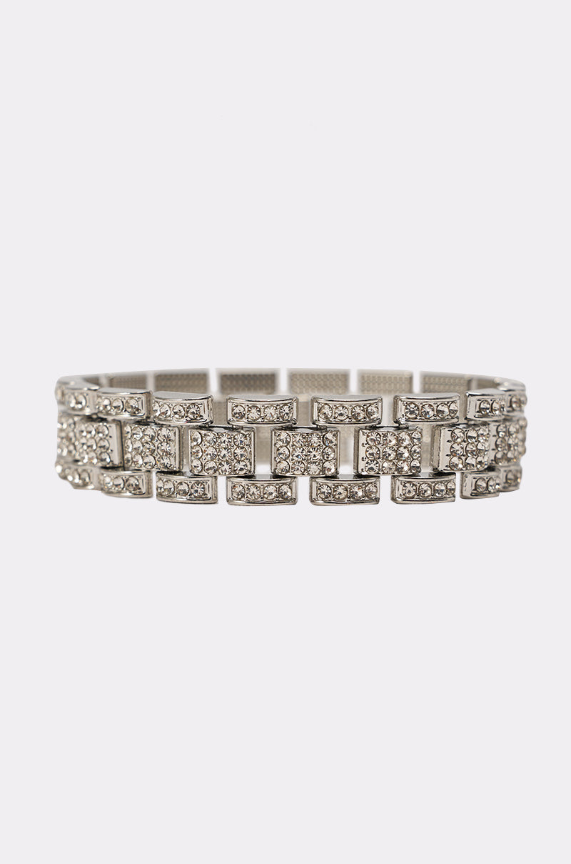 The BABY ICE ME OUT BRACELET features rectangular silver links adorned with clear rhinestones in a repeating geometric pattern, displayed elegantly on a plain white background. 2