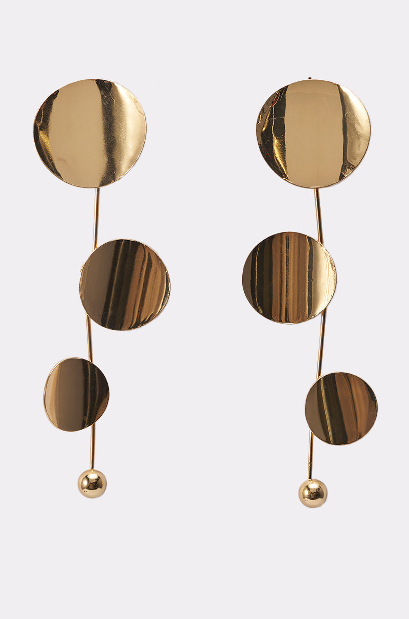 The DEDE EARRING features modern gold drop earrings with three differently sized circular discs linked by slim vertical rods and finished with a small gold sphere for a bold statement look. 0