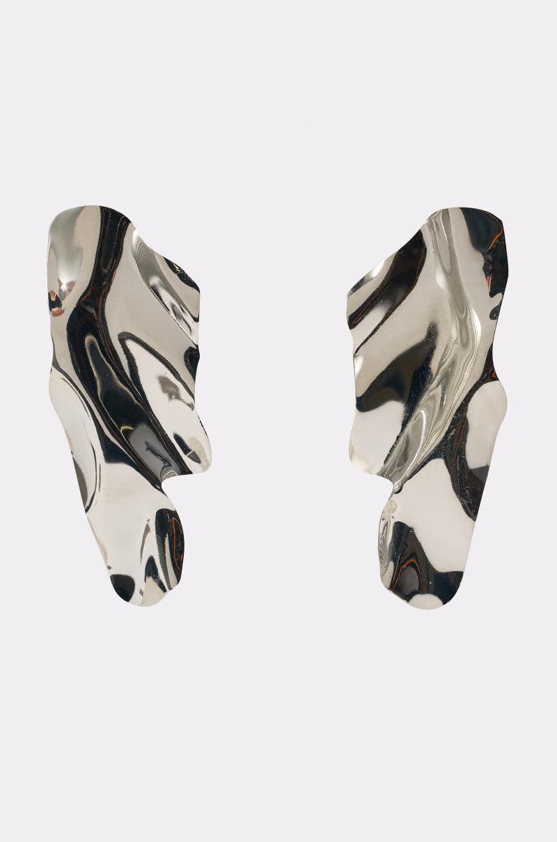 The CHROME GAL EARRING features abstract, irregular sculptural drop shapes with a shiny silver finish and organic wavy contours, shown against a plain white background. 0