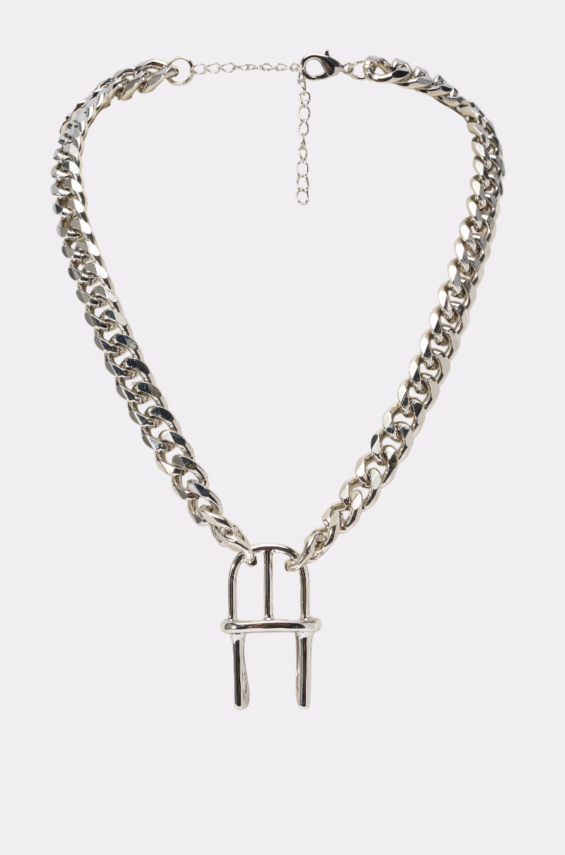 The SIT DOWN NECKLACE is a chunky Cuban chain featuring a large, uniquely shaped "H" pendant displayed on a plain light background.