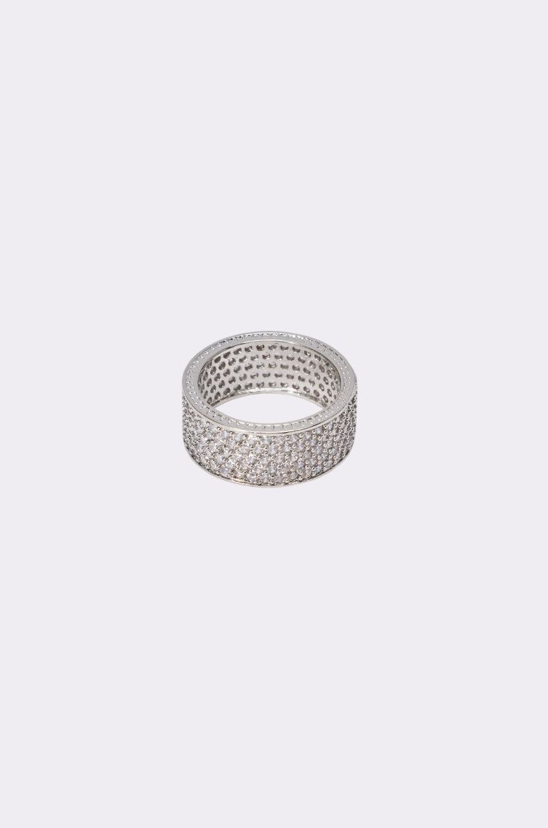 The TO INFINITY CZ RING features a wide stainless steel band adorned with multiple rows of sparkling white stones, displayed on a plain light gray background. 2