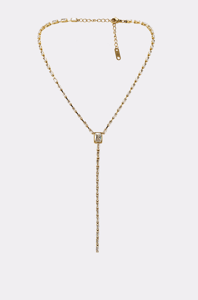The IM EXPENSIVE NECKLACE is a gold rhinestone lariat featuring a square clear gemstone pendant and a gem-studded vertical drop chain—perfect statement jewelry for special occasions, shown on a light gray background.