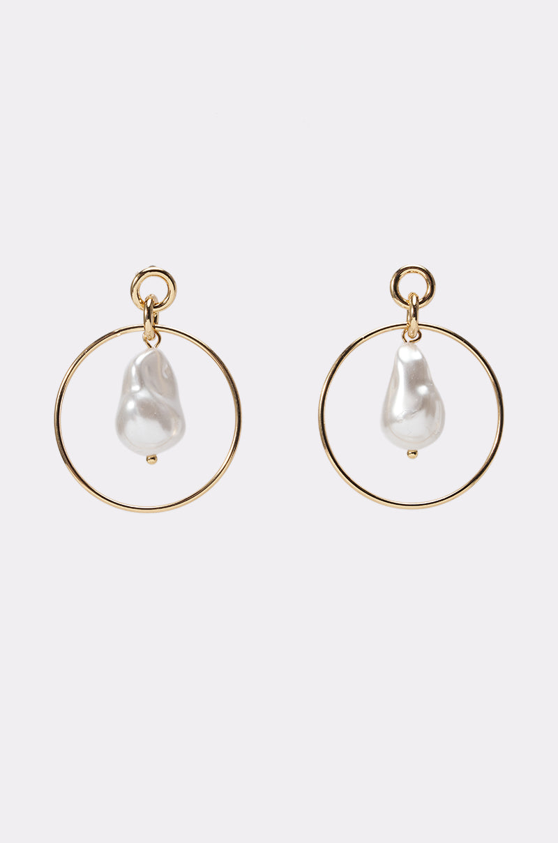 CALL ME MOTHER EARRING: Gold drop earrings each adorned with a single dangling, irregular-shaped white pearl, shown against a simple light background.