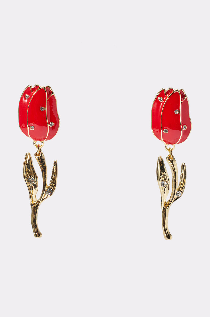 The ROSES ARE RED EARRING features red tulip-shaped flowers with gold stems and leaves, accented by small clear stones, all beautifully displayed against a plain white background.
