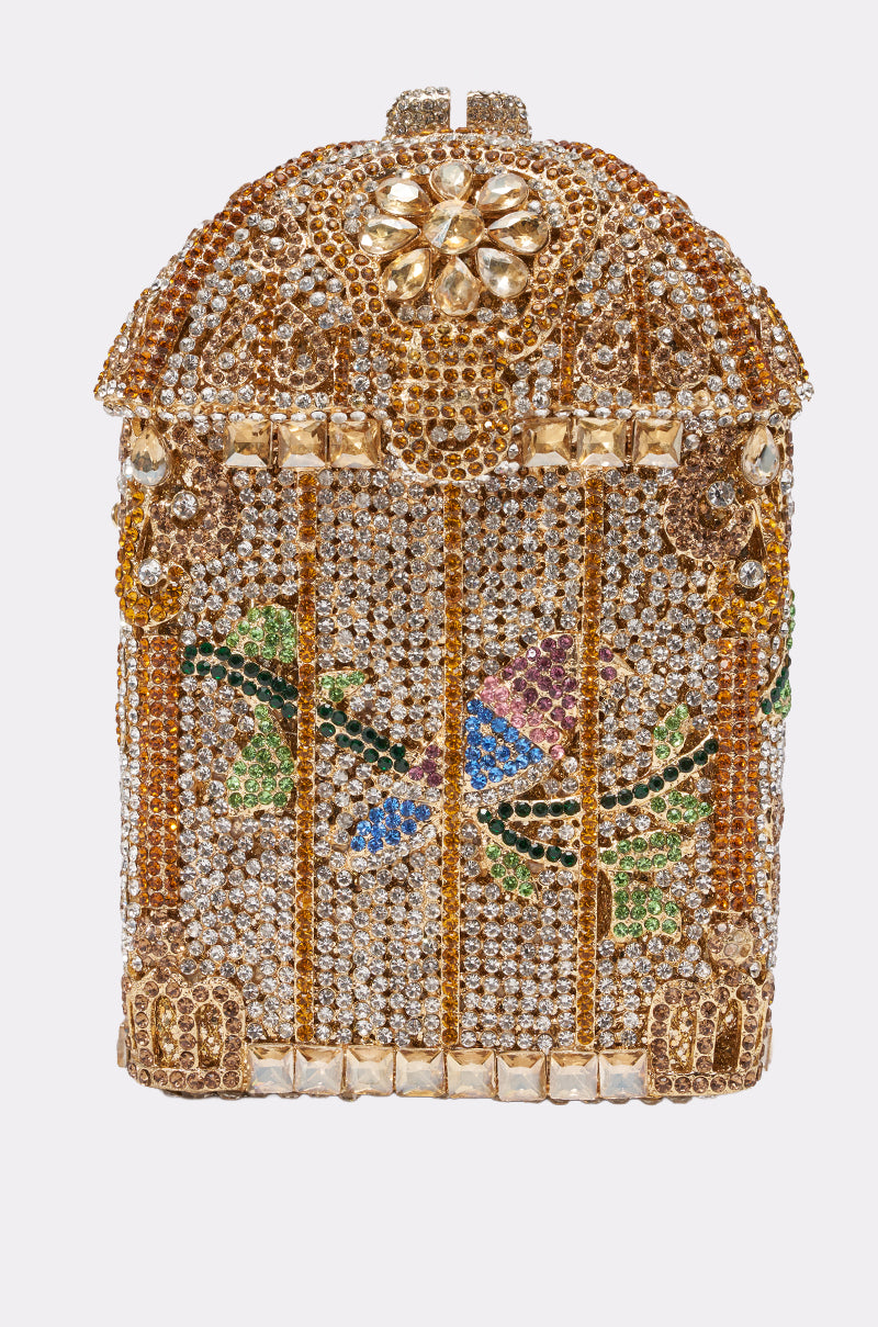 The EXQUISITE BLING LUXE CLUTCH is a birdcage-shaped rhinestone evening bag, adorned with gold and clear gems, and features a colorful bird with green leaves inside—a dazzling purse for any occasion.