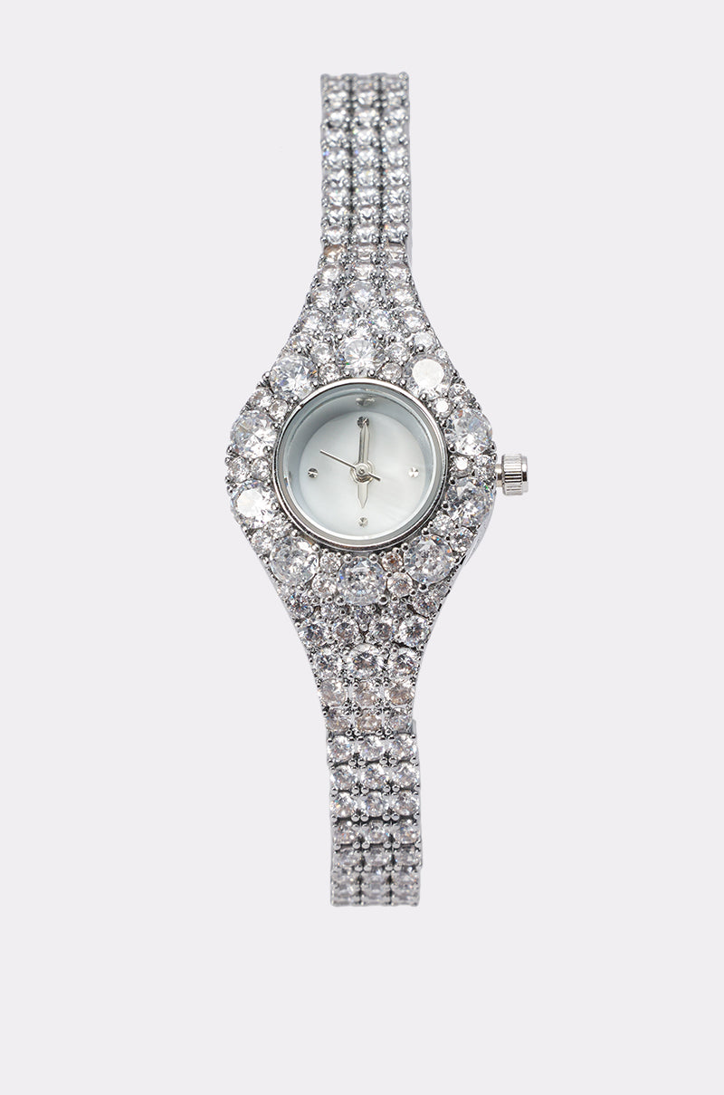 The ICE PRINCESS WATCH is an elegant ladies dress watch with a slim band, fully encrusted in shiny clear rhinestones, featuring a small round face and metallic hands against a plain light background.