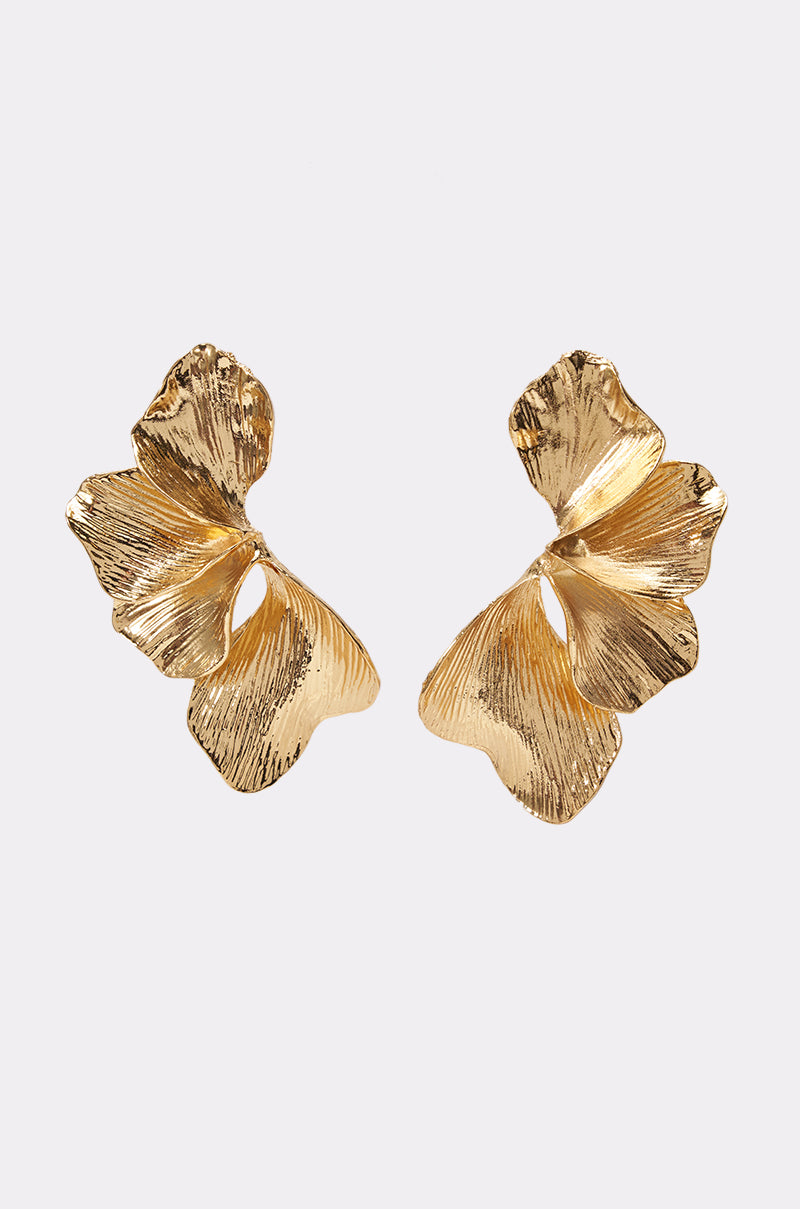 SCULPTED FLORAL EARRINGS: A pair of gold earrings crafted to evoke abstract, textured ginkgo leaves with delicate, wavy edges—an elegant choice for a summer date night, featured against a simple light background.