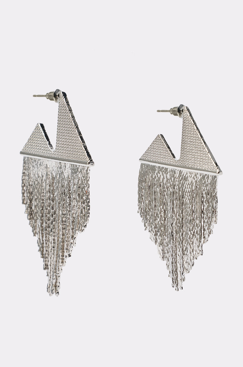 Introducing the METALLIC FRINGE EARRINGS—silver geometric earrings featuring striking triangular tops and cascading chain fringe below. Perfect for making a bold statement, these silver triangle fringe earrings will elevate any festival jewelry collection. Displayed against a plain white background.