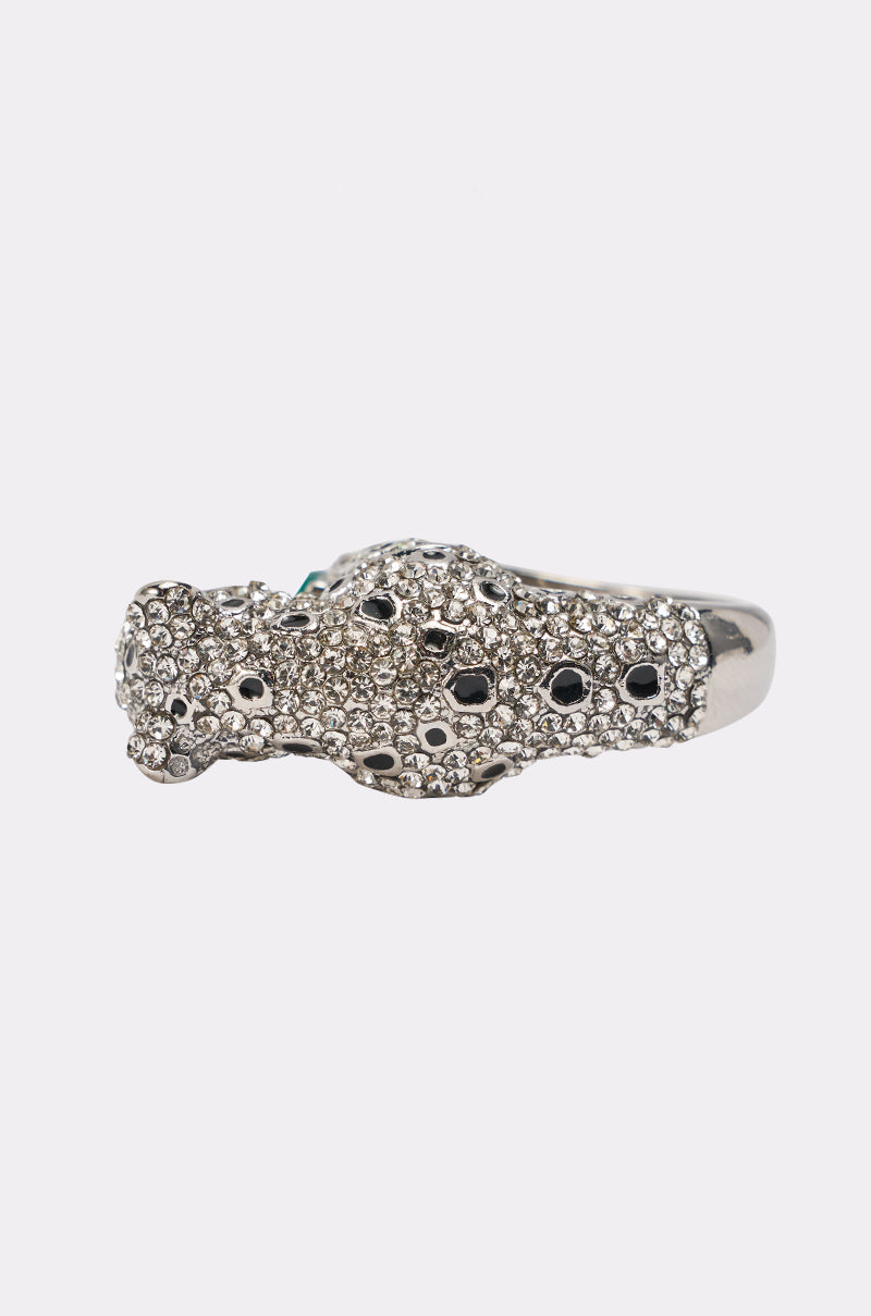 The LUXE JAG RING features a panther-shaped design inspired by jaguars, embellished with clear crystals, black spots, and emerald green gem eyes—perfect statement jewelry against a plain white background. 3