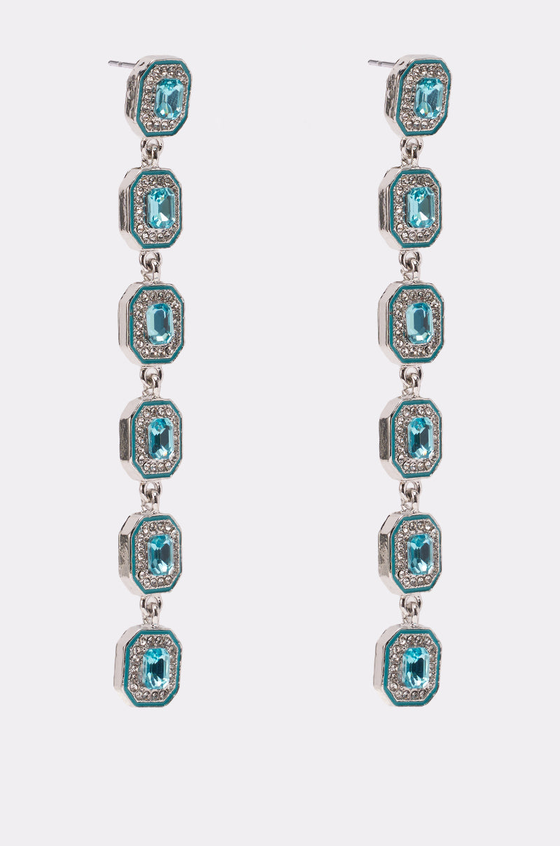 The TOO RICH EARRING features five rectangular aqua blue gems, each bordered by sparkling rhinestones and arranged vertically in a bold geometric drop design. 2