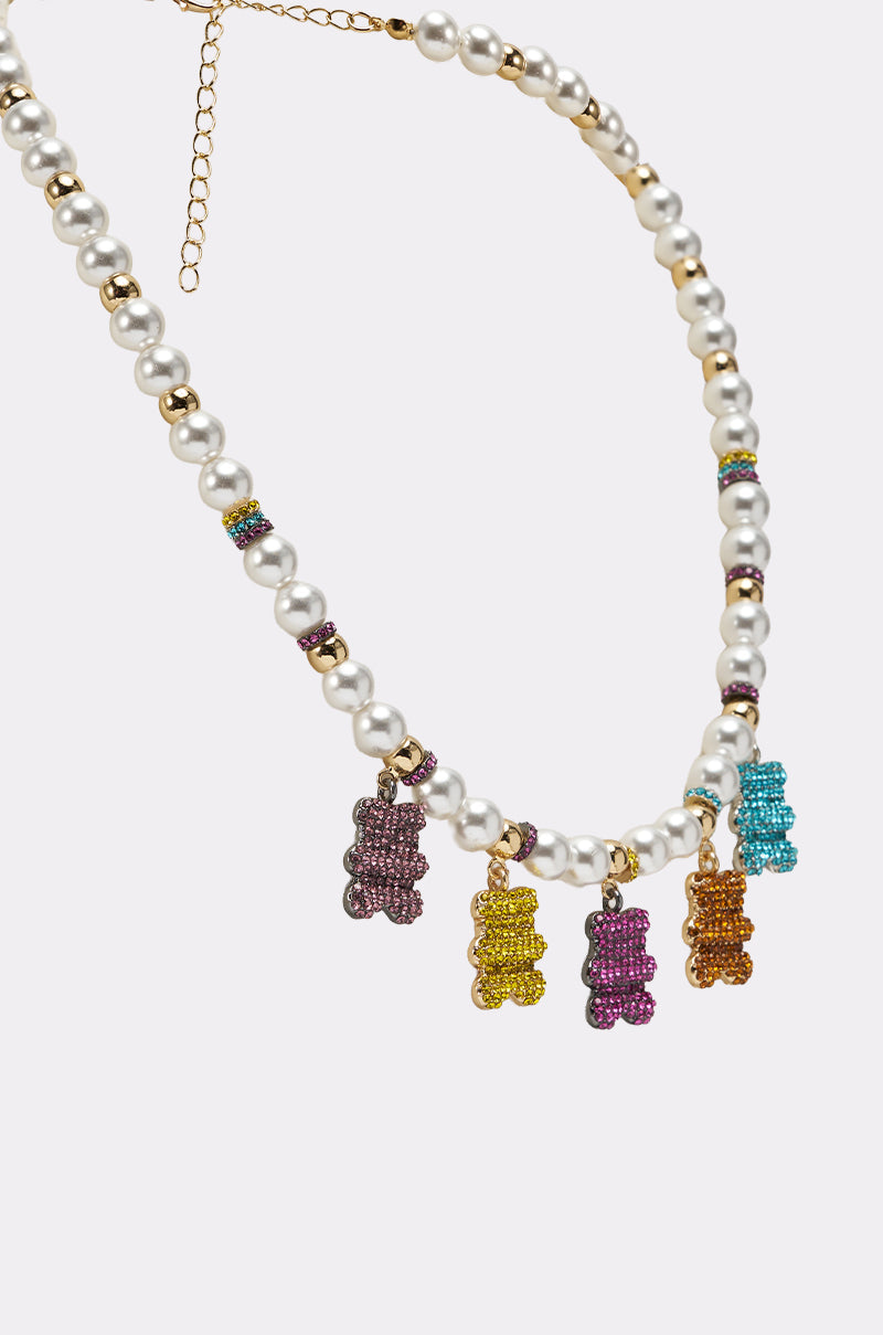 The LUXE BEAR CHARM NECKLACE features alternating gold and faux pearls, colorful spacer beads, and five gummy bear-shaped pendants in purple, yellow, pink, orange, and blue. 4