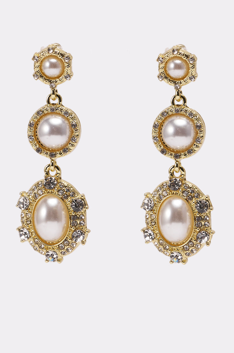 The REGENCY EARRING features round and oval faux pearls with sparkling crystal accents in an ornate, vintage-inspired gold design, displayed on a white background. 3