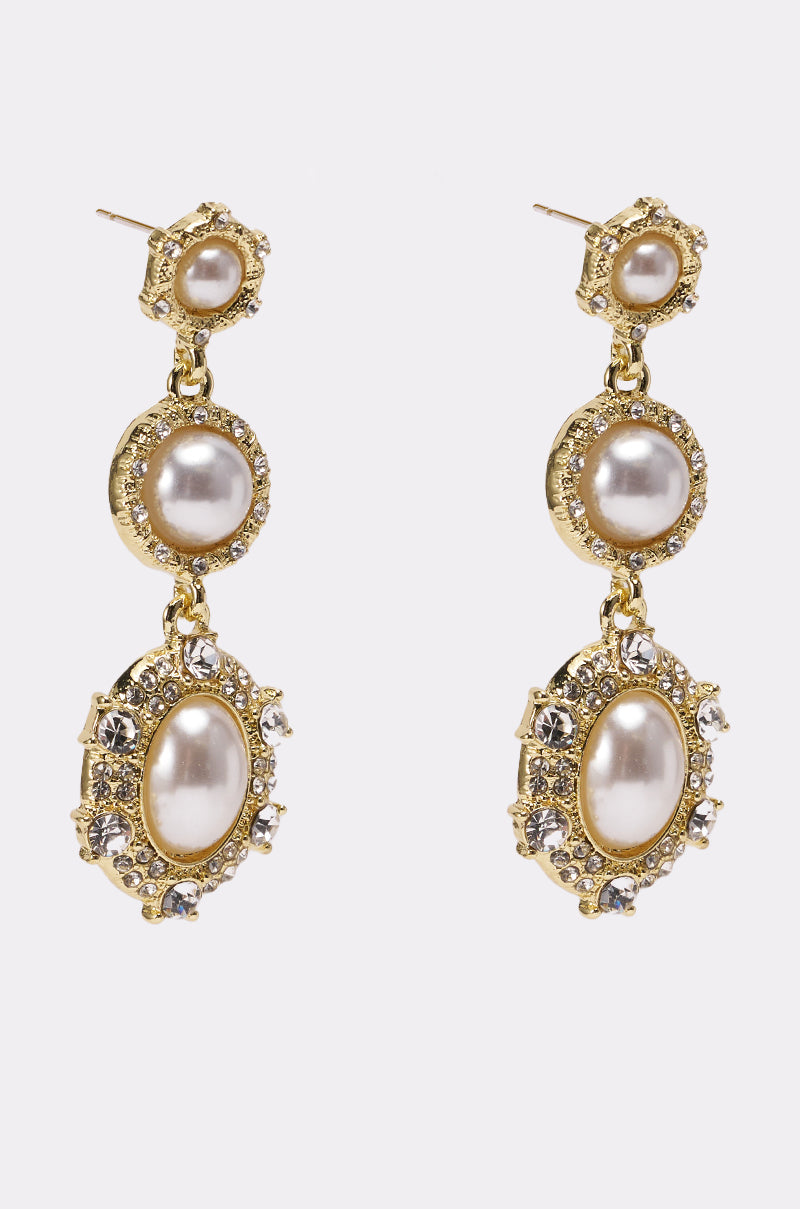 The REGENCY EARRING features three gold pearls in round and oval designs with sparkling crystal accents, creating a vintage-inspired look. Shown against a plain white background. 5