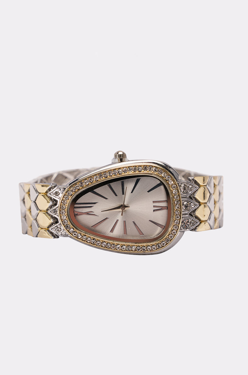 The LUXE LIVING WATCH boasts a teardrop face with black hour markers, diamond-like stones on the bezel, and a mixed-metal bracelet with a hexagonal pattern for a distinctive, elegant style. 0