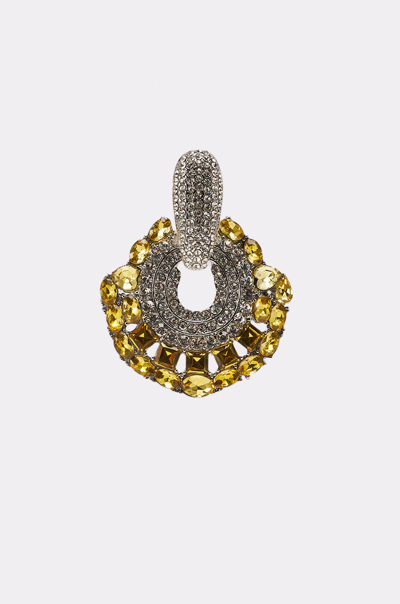 The LUXE TIS THE SEASON EARRING features a silver, rhinestone-studded loop and a semicircular design with yellow gemstones, pairing beautifully with rhinestone accessories for an elegant look against a plain white backdrop. 3