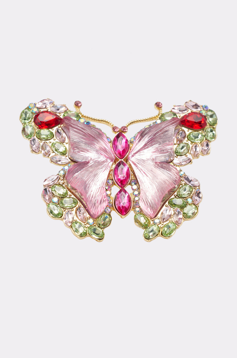 The SPREAD YOUR WINGS RING features a jeweled butterfly design with pink wings, a red and pink gemstone body, gold accents, and green, clear, and red gemstones outlining the wings, shown on a plain white background. 3