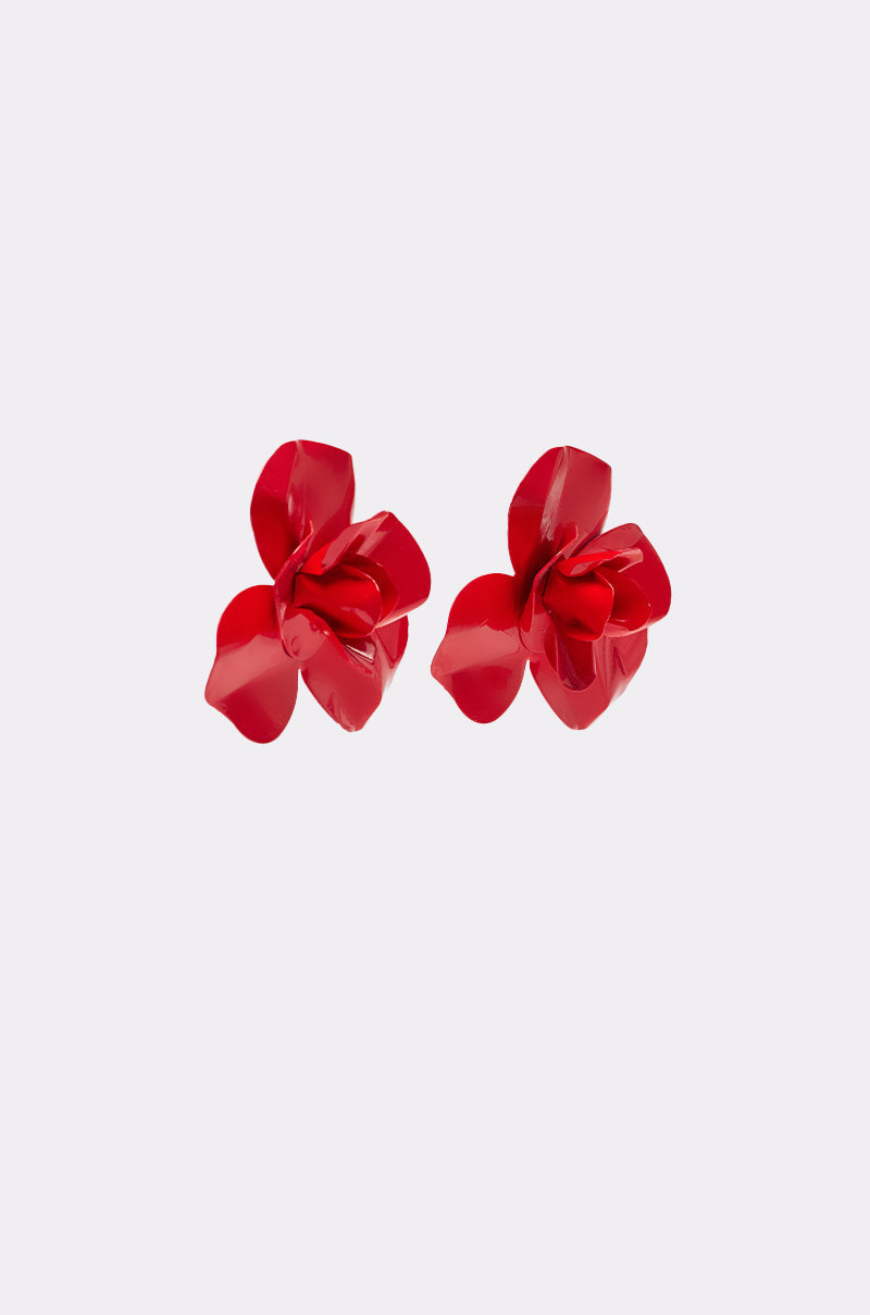 The GALA EARRING is a pair of crimson statement earrings featuring glossy, flower-shaped petals, shown against a plain light gray background. 2