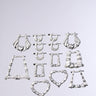 The I AM THE VIBE HAIR CLIP SET features nine silver hair clips in statement shapes—hoops, rectangles, squares, triangles, and hearts—arranged in three rows on a plain gray background. Each has a chunky texture perfect for bold hairstyles.