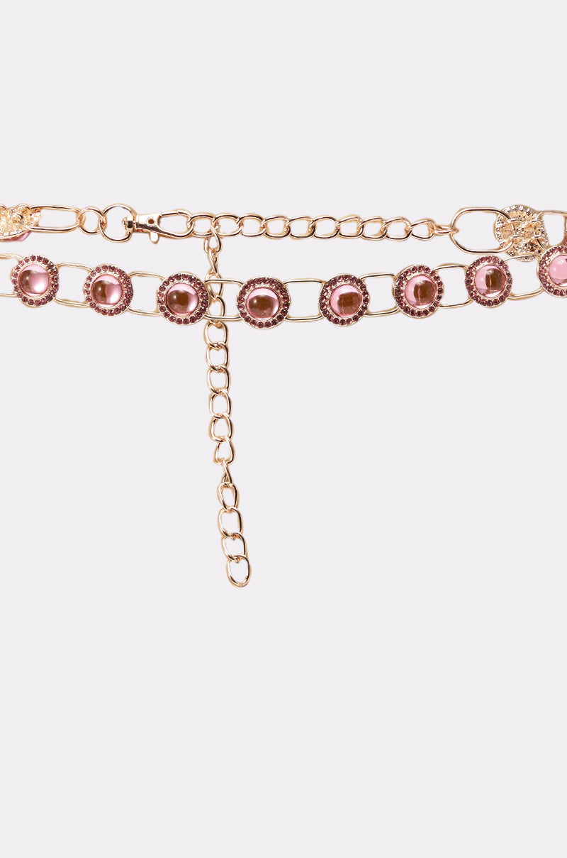 The ON A BOAT CHAIN BELT is a gold-tone chain belt with decorative pink gem-like stones and an adjustable clasp, shown on a white background. 3