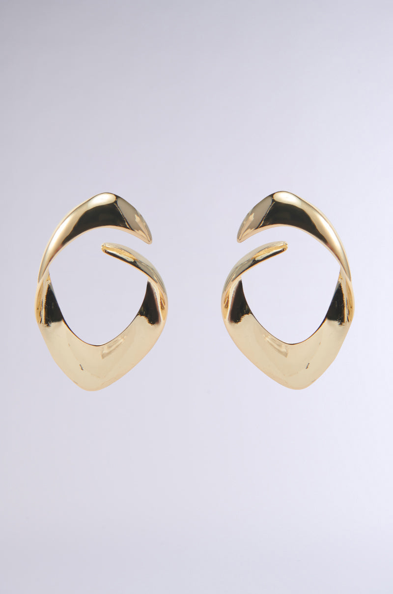 The LOVERGIRL EARRING, crafted in faux gold with an abstract open-loop design, is perfect for a date night. Set against a plain white background, these earrings radiate modern sophistication and style. 3