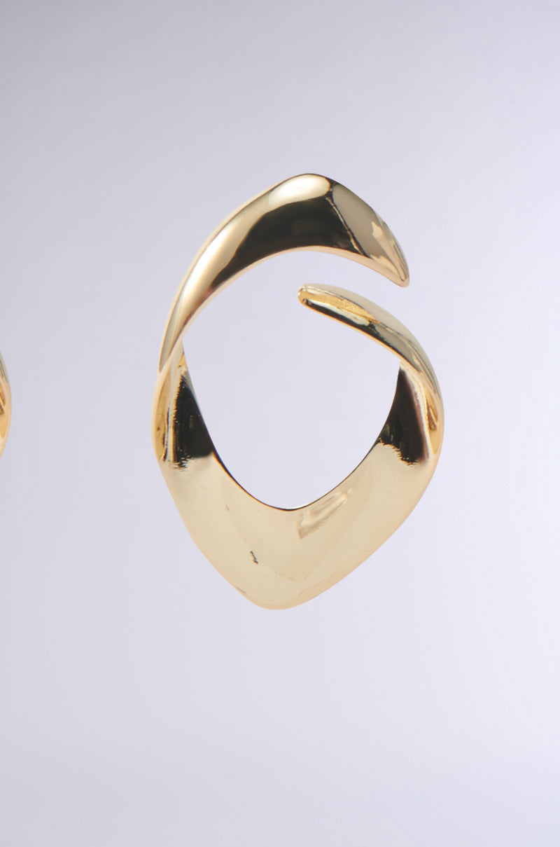 The LOVERGIRL EARRING, made from faux gold, boasts a shiny, abstract design with smooth curves. Its spiral shape varies in thickness for a sophisticated allure against a plain light gray background—ideal for adding elegance to your date night look. 6