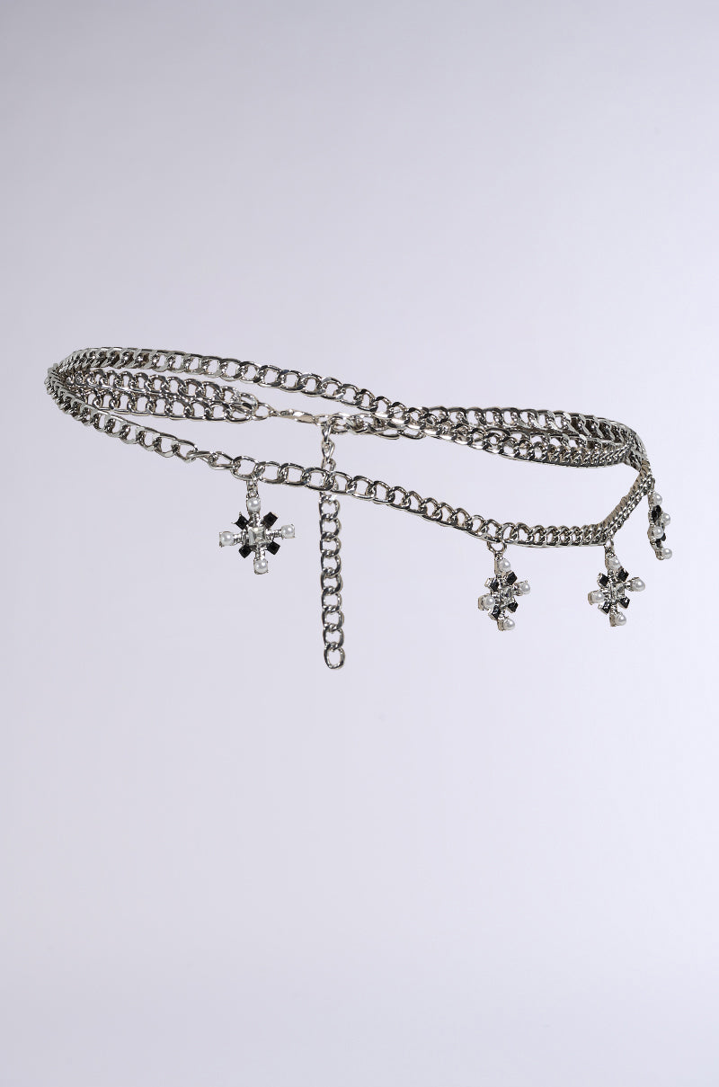The DON'T CROSS ME BELT IN SILVER, featuring cross pendants adorned with tiny rhinestones, is elegantly showcased on a plain gray background, making it the perfect festival accessory. 3
