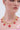 Wearing the PICK ME RED NECKLACE featuring rhinestones, red heart-shaped charms, and small gold flowers with a pink off-the-shoulder top—only the lower face and neck visible—makes this necklace the perfect summer accessory.