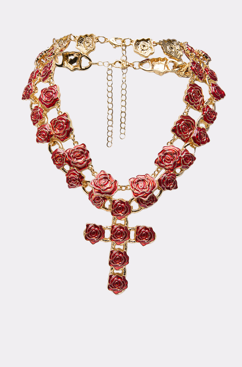 The ROSES ARE RED NECKLACE SET features a gold-tone chain with heart-shaped links, red rose accents, and a matching cross pendant adorned with red roses. 0