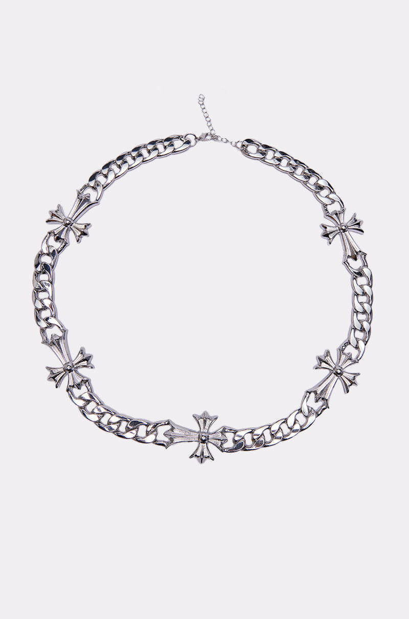The ITS OFFICIAL NECKLACE is a chunky silver chain adorned with five ornate cross-shaped charms, evenly spaced and shown against a plain white background.
