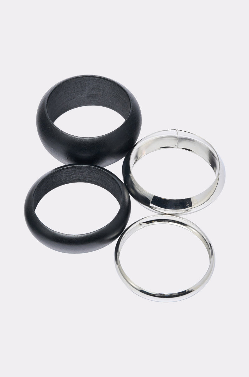 The MOD BRACELET SET features four rings on a white background: two matte black and two silver-toned with a shiny, reflective finish—perfect for fans of minimalist jewelry. 3