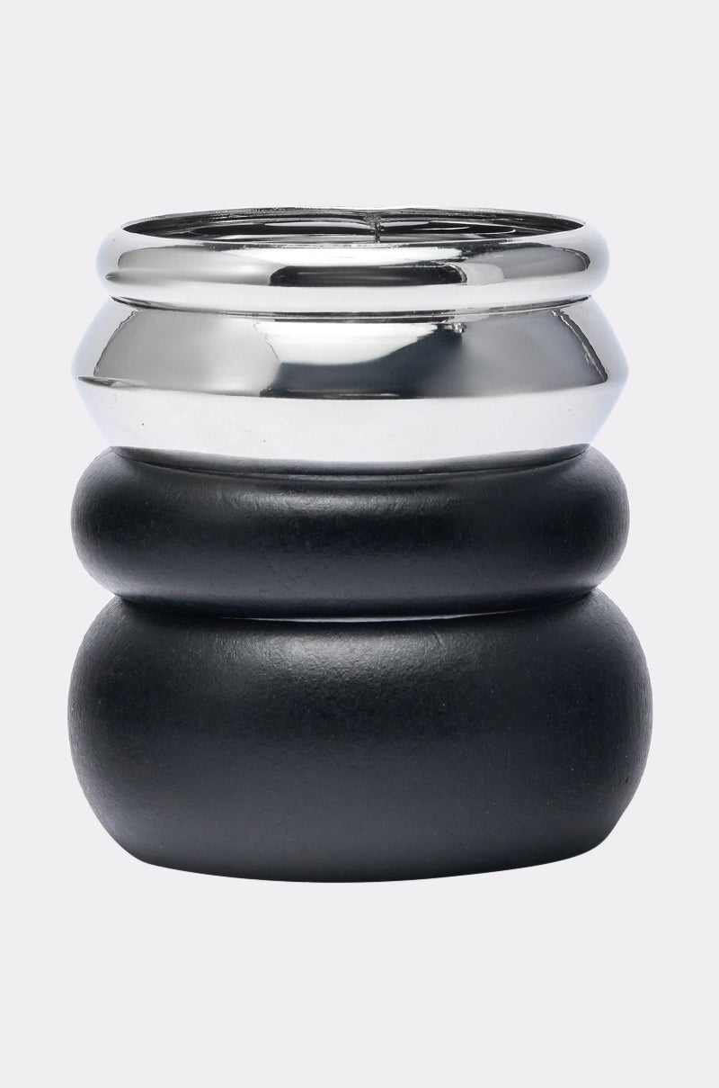 The MOD BRACELET SET features a stacked, sculptural look with matte black and polished silver bands—perfect for pairing with minimalist accessories or your favorite silver-tone bangles. 5