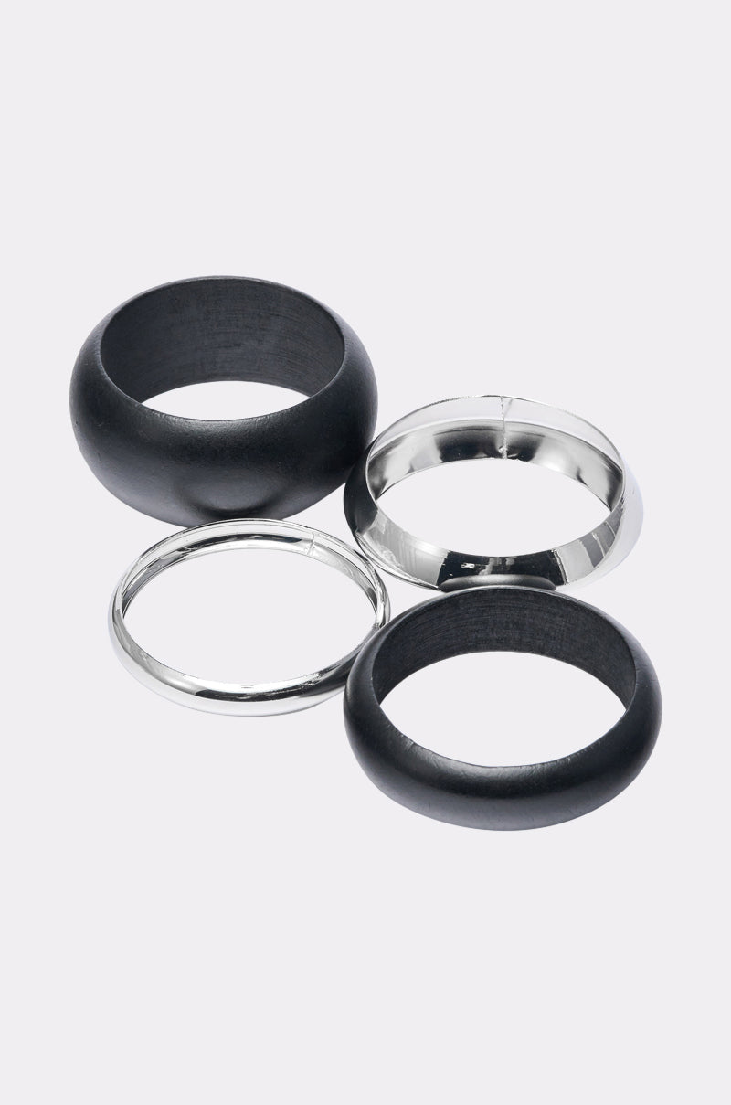 The MOD BRACELET SET features four rings on a light gray background: two smooth, shiny silver bands and two slightly thicker matte black bands, showcasing a modern, stylish look. 6