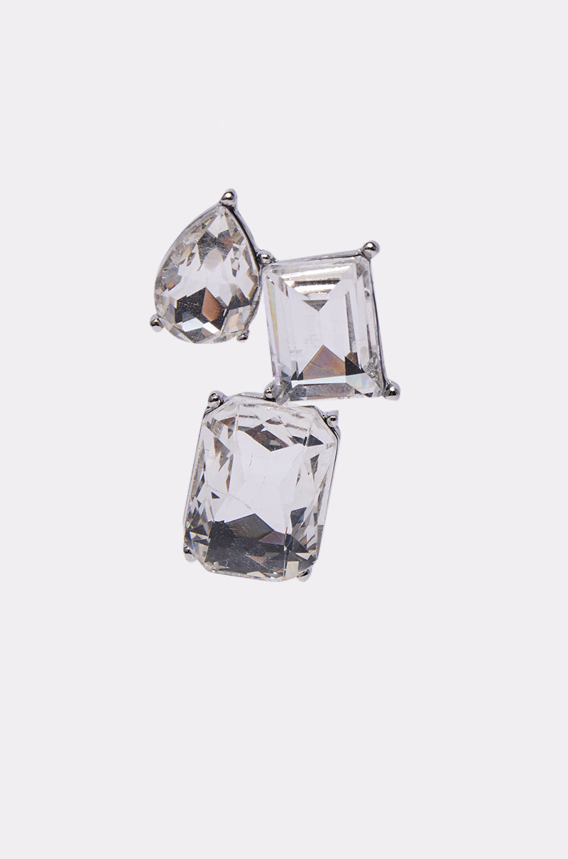 Three clear gemstones in pear, square, and rectangular cuts create striking clusters set in silver-tone prongs—the COUNTDOWN EARRING stands out elegantly against a plain white background. 4