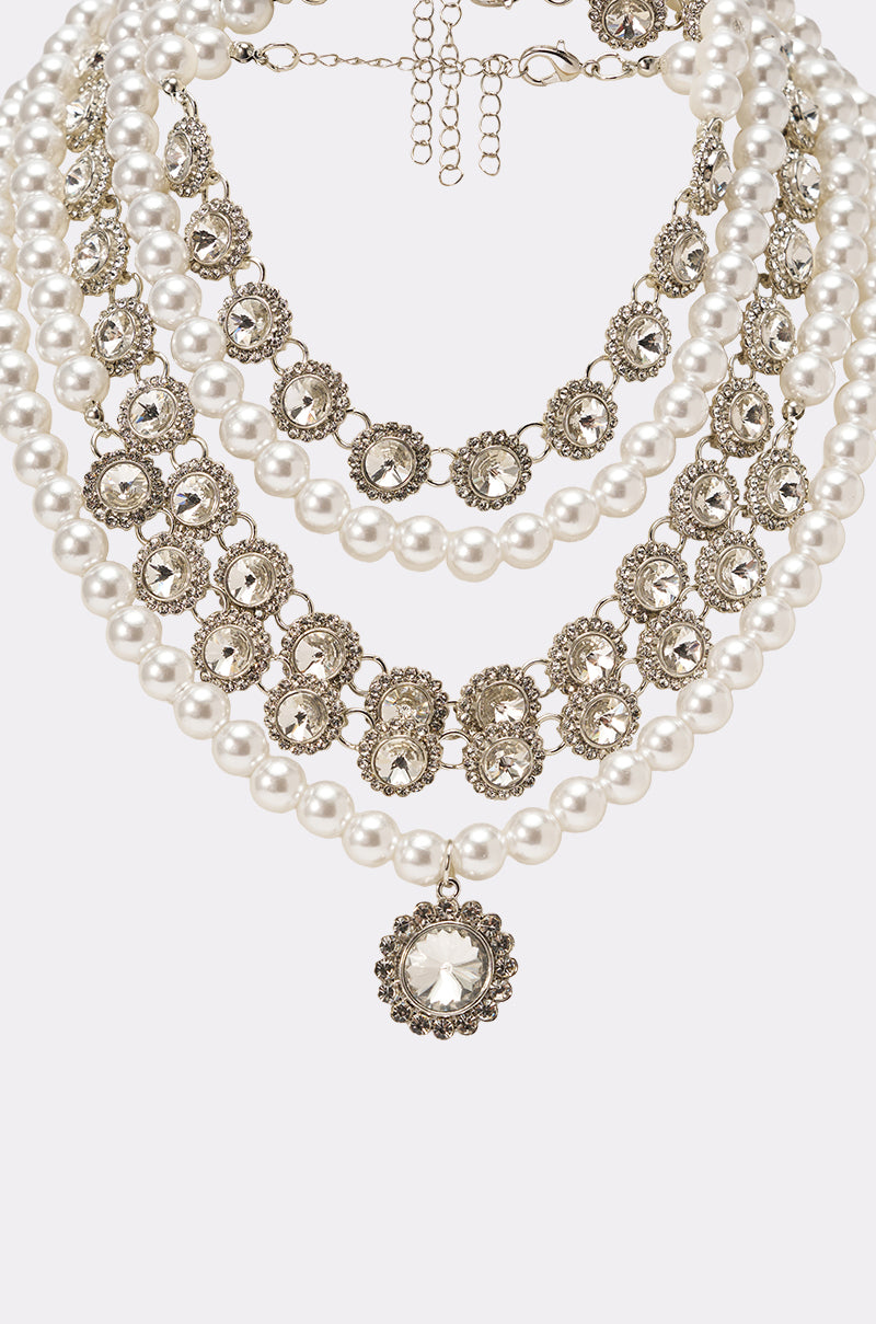 AFFORD IT NECKLACE: Vintage-inspired, layered white pearls and ornate silver medallions with a round floral pendant and adjustable chain. An elegant statement necklace for any occasion, showcased on a clean white background. 3