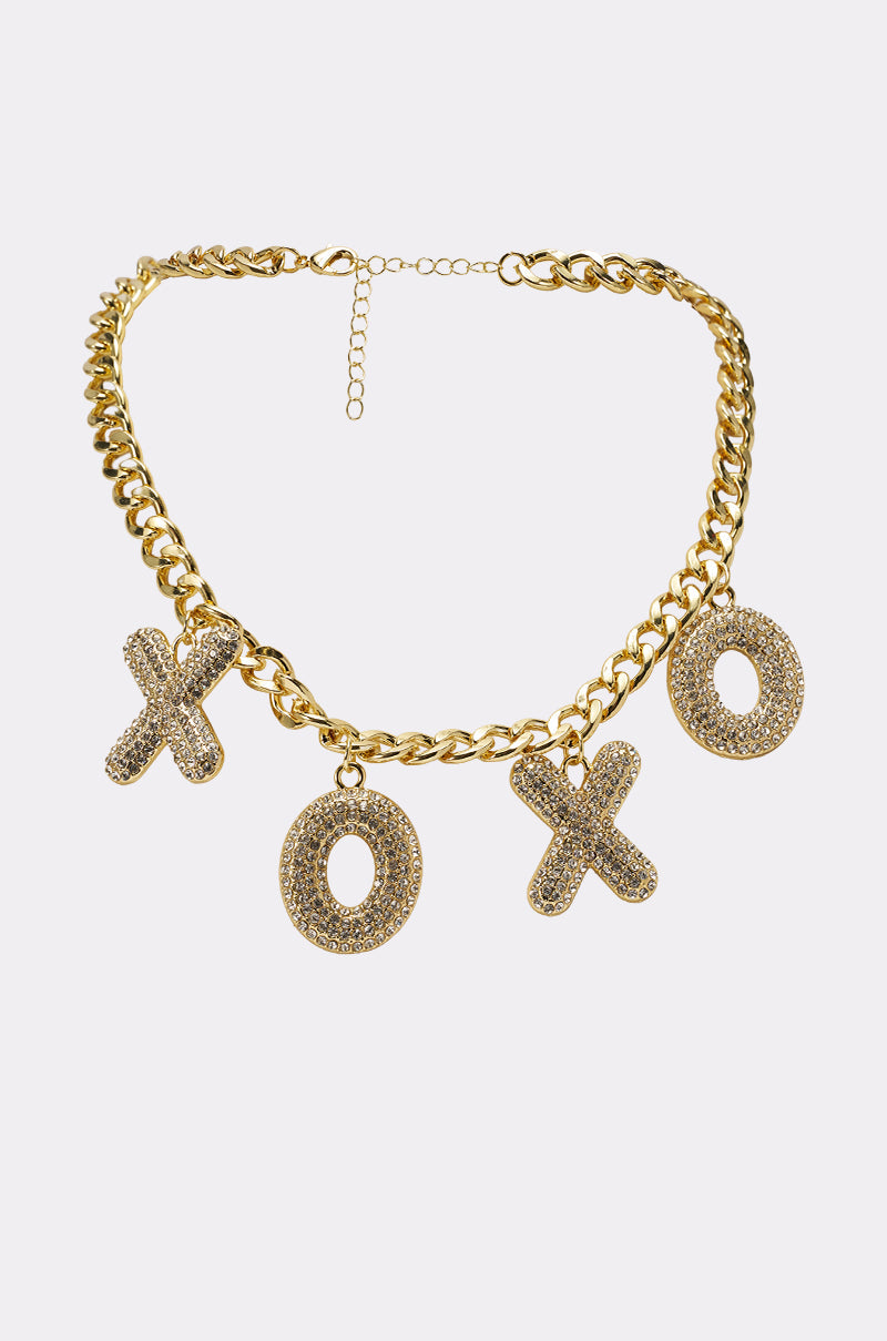The KISSES NECKLACE is a gold charm necklace with three glittery XO pendants on an adjustable pavé chain, adding sparkle and playfulness to your look. 1