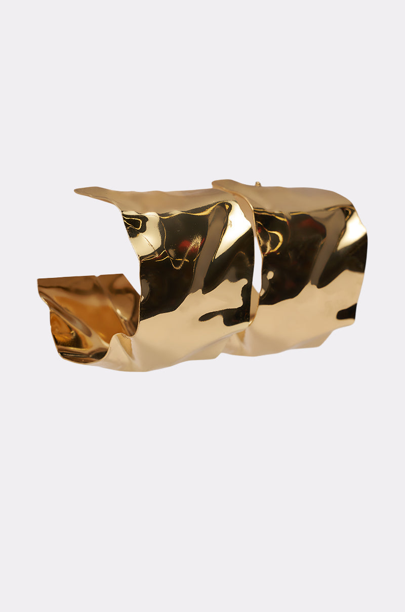 A pair of wide, shiny gold BENT OUTTA SHAPE EARRING with a crumpled, textured finish and open ends, displayed against a plain white background. 2