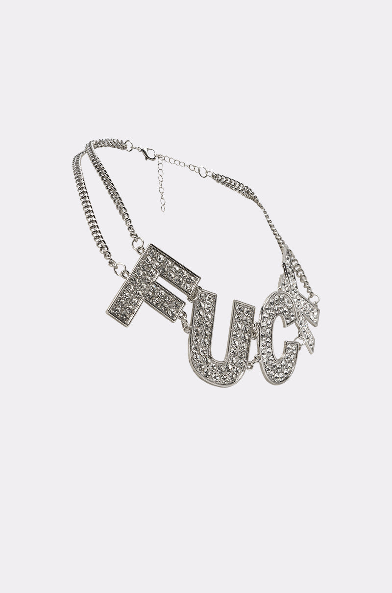 The ME NECKLACE is a rhinestone statement necklace with large crystal pendant letters spelling "ME," each encrusted with sparkling stones—a striking piece of festival jewelry, shown on a white background. 2